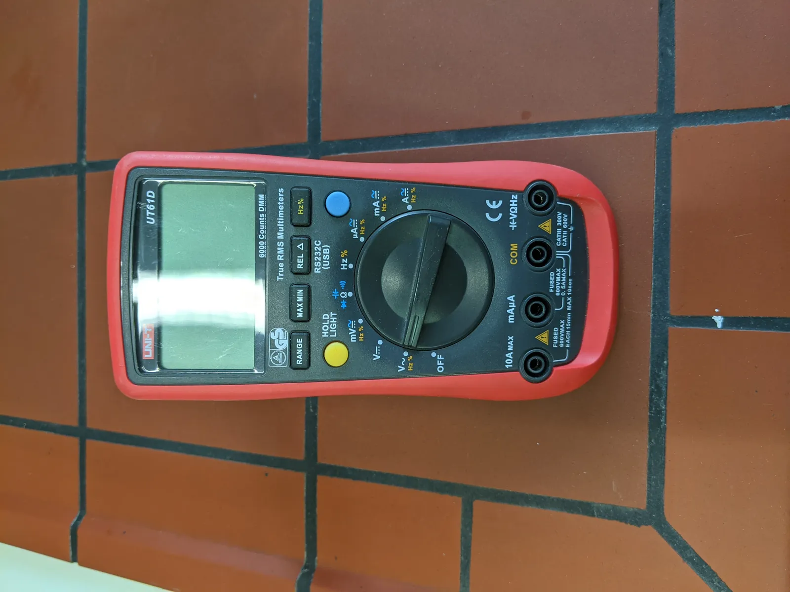 Digital multimeter used to check solar battery voltage during troubleshooting.